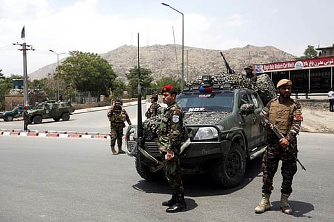Afghan security forces keep watch at the site of a suicide attack in Kabul
