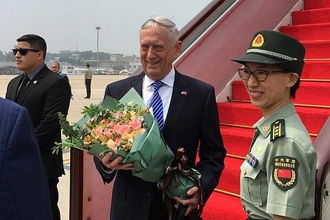 US Defense Secretary Jim Mattis receives a bouquet upon arrival at an airport in Beijing, China