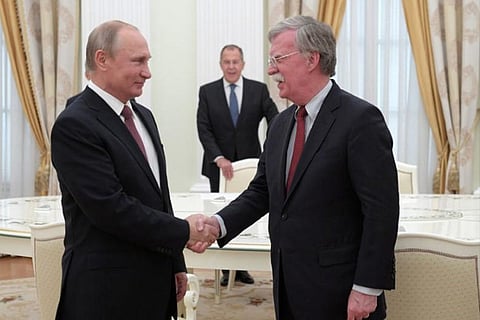 Russia's President Vladimir Putin (L) meets with U.S. National Security Adviser John Bolton