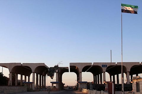 A Syrian opposition flag is erected at the Syrian-Jordanian border