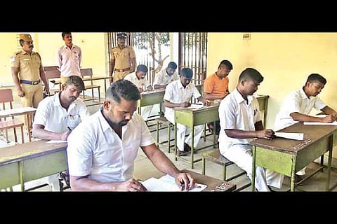 Image of prison inmates writing exam used for representative purpose