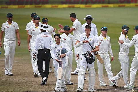 Australian players celebrate after winning the first Test