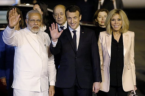 India's PM Modi, French President Emmanuel Macron and his wife  Brigitte Macron wave to the media