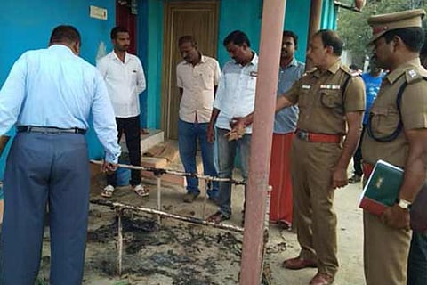 A police officer inspects the scene