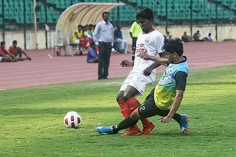Income Tax?s Wayne D?Silva (R) battles for the ball with an Arrows FC player (Photo: Justin)