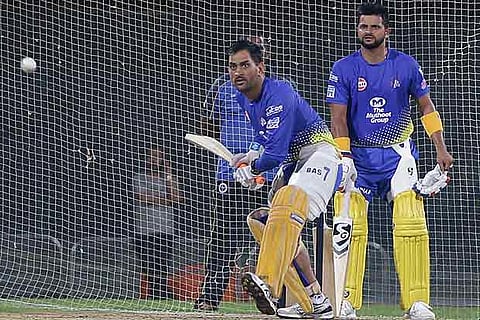 Watched by vice-captain Suresh Raina, Chennai Super Kings captain MS Dhoni bats during a net session