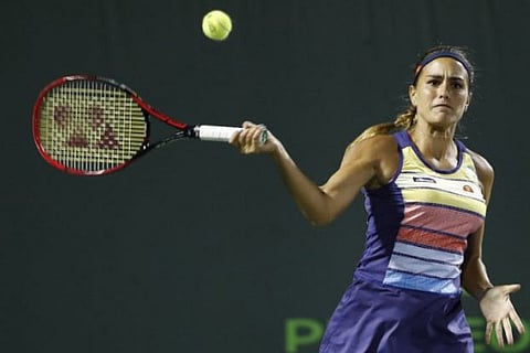 Monica Puig hits a forehand against Caroline Wozniacki