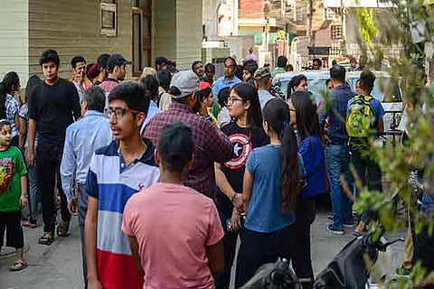 Students and parents gather outside a coaching center in Rajendra Nagar as Delhi Police search(PTI)