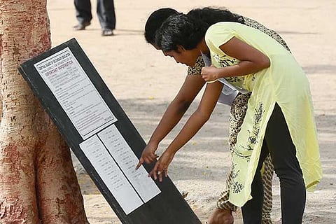 Candidates check the rules ahead of the NEET exam at Kendriya Vidyalaya, Meenambakkam