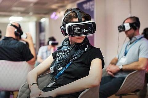 A woman wearing a virtual reality (VR) headset at the 71st Cannes Film Festival