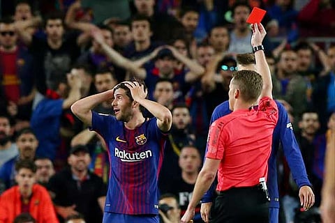 Barcelona's Sergi Roberto is shown a red card by referee Alejandro Hernandez