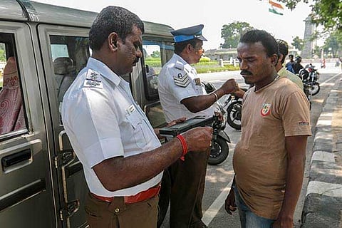 raffic police seen issuing spot fine receipts to violators