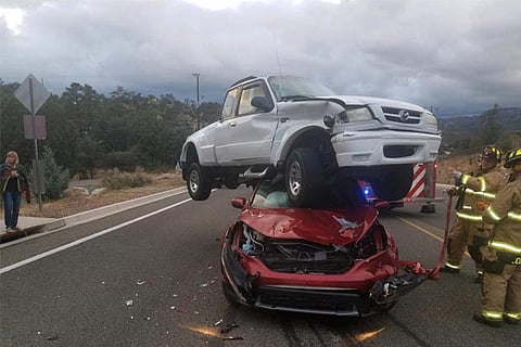 Firefighters look on at the scene of a vehicular crash in Prescott, Arizona, U.S.