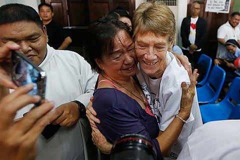 Australian Roman Catholic nun Sister Patricia Fox (r) is hugged by a supporter before her departure