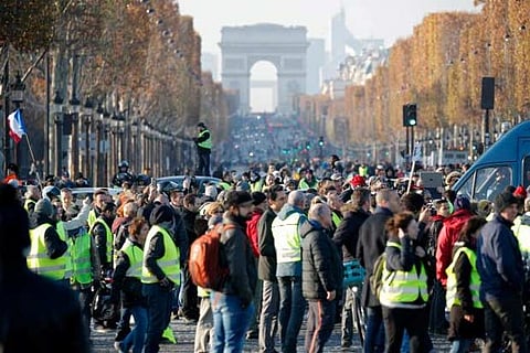 People wearing yellow vests, a symbol of a French drivers' protest against higher fuel prices.
