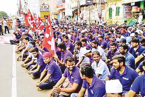 Employees of Yamaha Motor protesting at the Kancheepuram bus terminus on Tuesday
