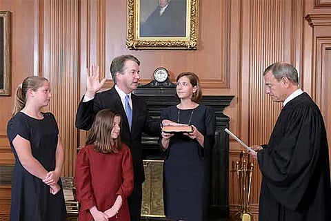 Judge Brett Kavanaugh is sworn in as an Associate Justice of the U.S. Supreme Court as family watches
