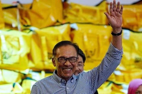 Malaysia's politician Anwar Ibrahim celebrates after winning the by-election