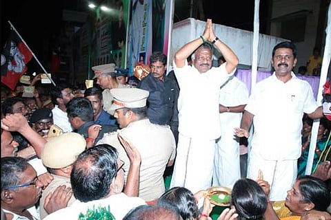 Deputy Chief Minister O Panneerselvam greets supporters at the public meeting on Saturday