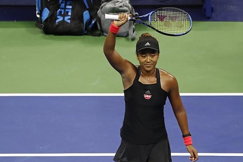 Naomi Osaka of Japan salutes the crowd after her match against Madison Keys of the United States