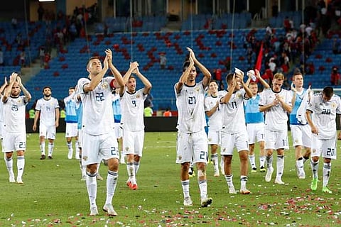 Russia's Artem Dzyuba, Alexandr Erokhin and team mates celebrate after the match