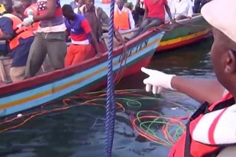 Rescue workers at the scene where a ferry overturned in Lake Victoria, Tanzania
