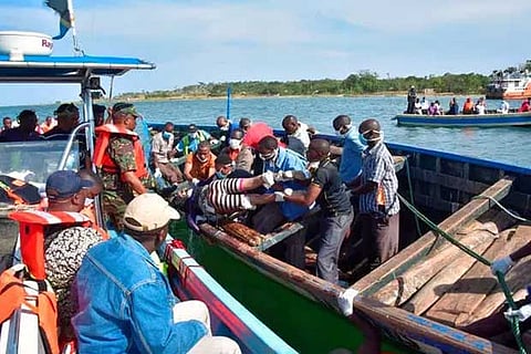 Rescuers retrieve bodies from the water after a ferry overturned on Lake Victoria, Tanzania