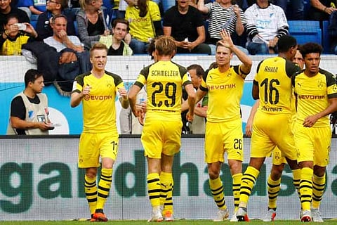 Borussia Dortmund's Christian Pulisic celebrates scoring their first goal with team mates