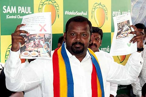 Sam Paul holds up a copy of the fake online post doing the rounds, during a media interaction