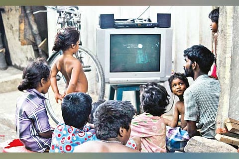 Kids watching TV on the street in Mannady