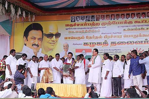 Chief Minister V Narayanasamy felicitating DMK president M K Stalin at a campaign meeting in Puducherry