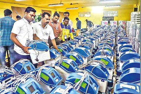 Polling officials check the VVPAT machines and other polling materials  in Chennai on Thursday