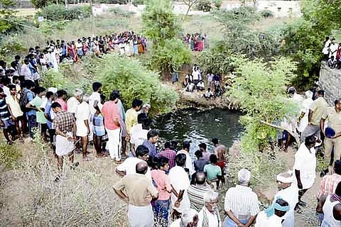 Villagers have gathered surrounding the open well during a search operation  by the fire and rescue personnel