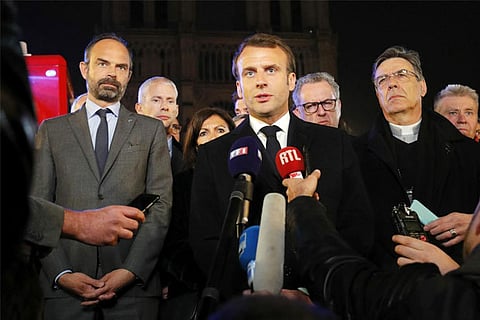 French President Emmanuel Macron addresses the media outside the Notre Dame