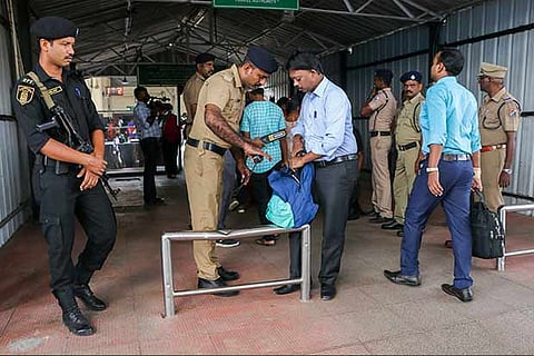 Railway police check baggages of passengers as part of the drill at Central railway station