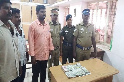 Flying squad officials with the seized money on Monday