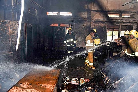 Fire fighters dousing the fire at BSNL office in Mannadi