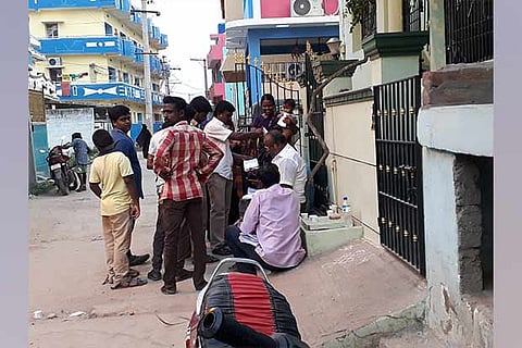 Party workers seen disbursing cash to voters at Mathina Nagar in Konavattam on Thursday