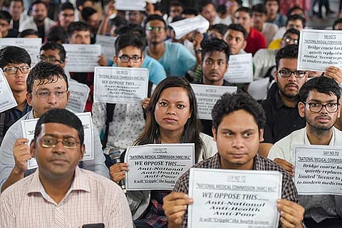 Doctors display placards during a strike to protest against the National Medical Commission bill