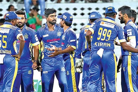 Rahil (centre) celebrates the wicket of Aaditya