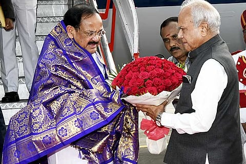 Vice President Venkaiah Naidu being received by Governor Banwarilal Purohit on his arrival  at Chennai airport