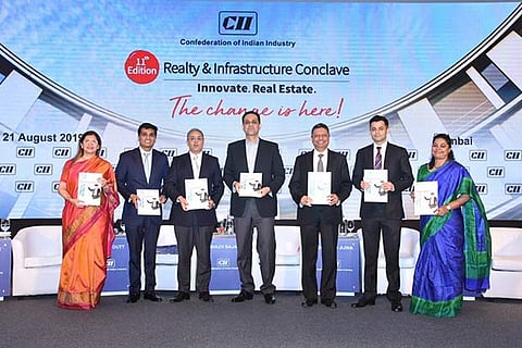 Dignitaries unveiling the CII-JLL report at the eleventh edition of ?CII Realty  Infrastructure Conclave?