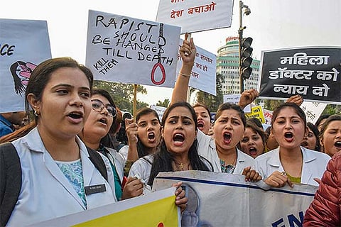 Nurses raise slogans and hold placards demanding justice in the relation to Hyderabad rape case