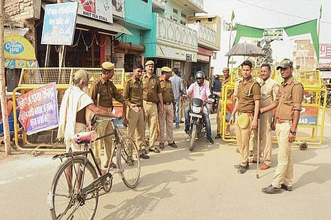 Security personnel frisk public in front of Meenakshi temple in Madurai on the eve of Babri Masjid demolition