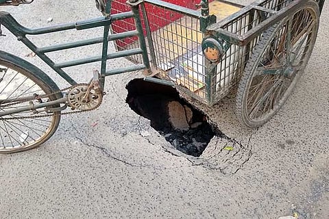 Road cave in was covered by a tricycle to alert the approaching vehicles