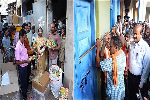Workers break open a godown in the presence of Vellore Collector