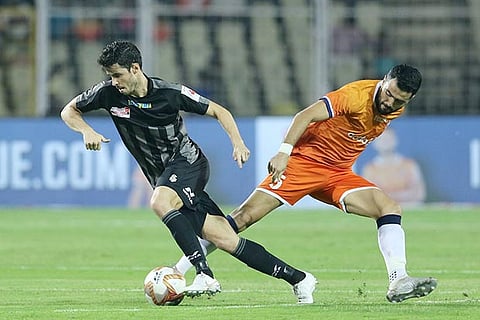 ATK?s Edu Garcia and FC Goa?s Ahmed Jahouh vie for the ball during their match in the ISL on Saturday