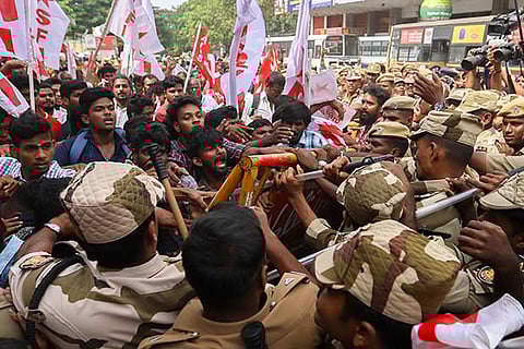 Police block the demonstrators protesting against the CAA in front of Central Railway Station on Saturday