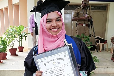 Rabeeha Abdurehim with her degree certificate