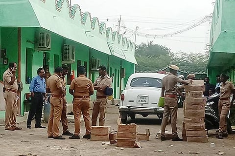The flying squad team with the unaccounted cash and liquor bottles at Kamuthi in Ramanathapuram district